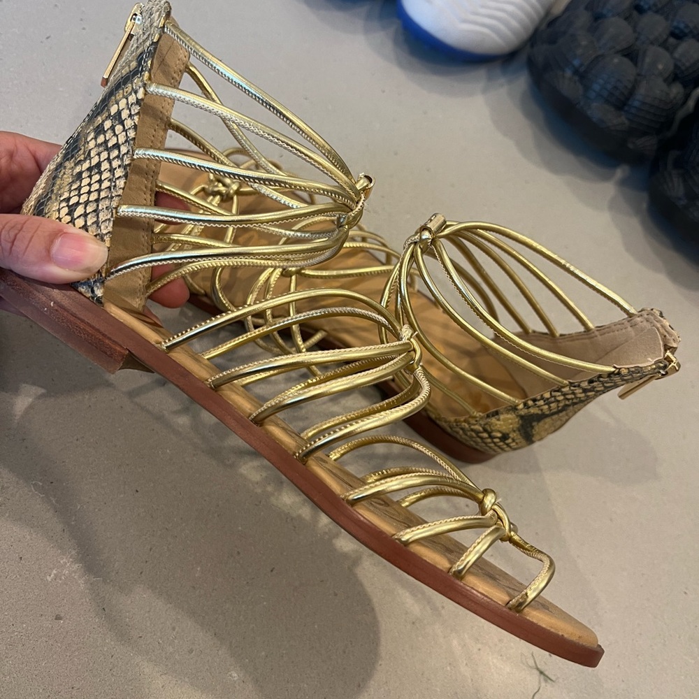 Sam Edelman gold gladiator style sandals with snakeskin back. Zip close.